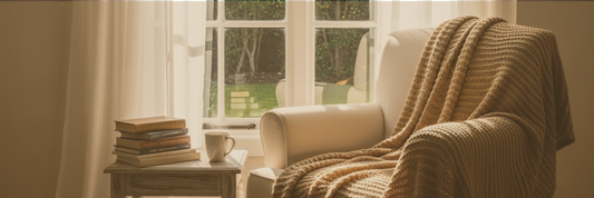 Cozy chair by window with books and mug